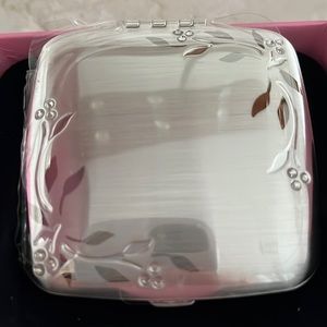Silver compact with double sided mirrors.